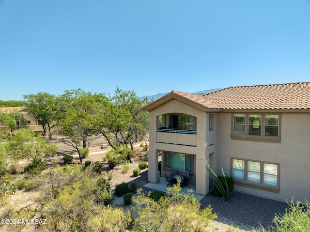 rear view of property featuring a balcony