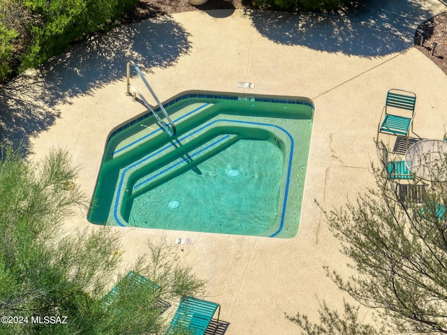 view of swimming pool with an in ground hot tub