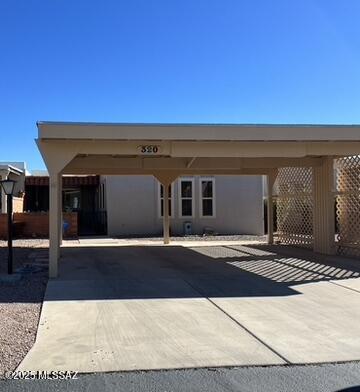 view of parking / parking lot featuring a carport