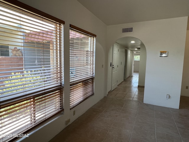 hall featuring dark tile patterned floors