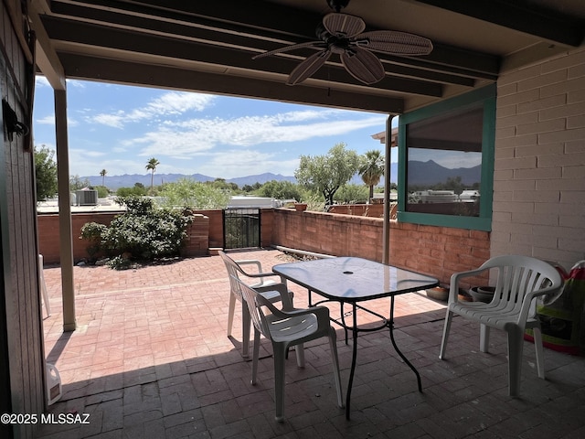 view of patio with ceiling fan and a mountain view