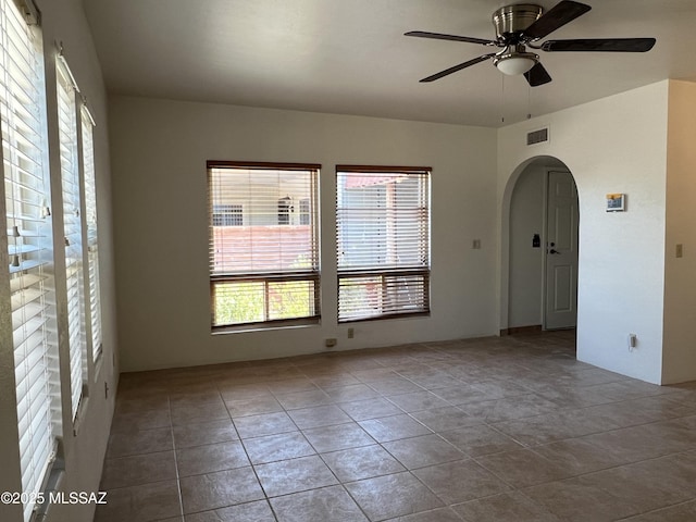 unfurnished room with ceiling fan, plenty of natural light, and light tile patterned floors