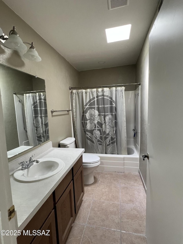 full bathroom featuring tile patterned flooring, vanity, shower / bath combination with curtain, and toilet