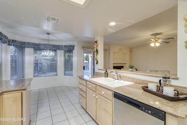 kitchen featuring light brown cabinetry, stainless steel dishwasher, ceiling fan, sink, and decorative light fixtures