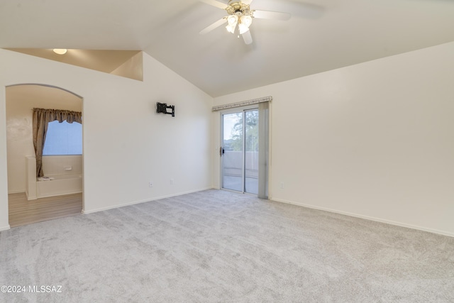 empty room with light carpet, ceiling fan, and lofted ceiling