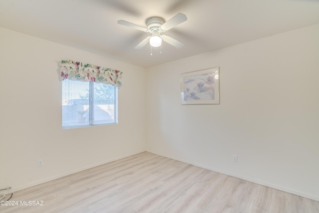 empty room with light hardwood / wood-style flooring and ceiling fan