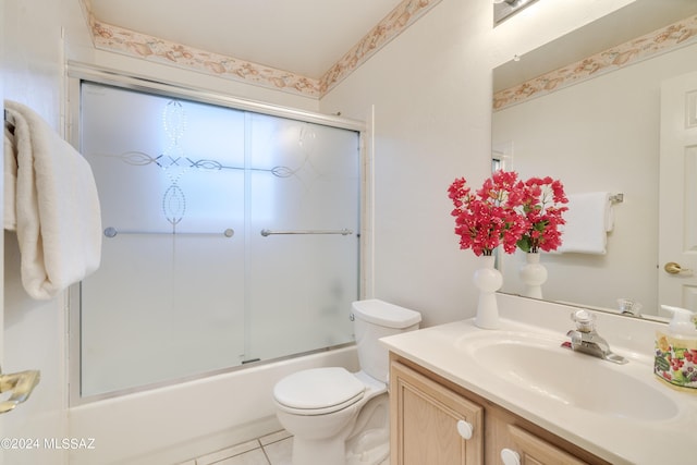 full bathroom with combined bath / shower with glass door, vanity, toilet, and tile patterned flooring