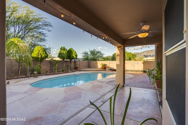 view of pool with ceiling fan and a patio area