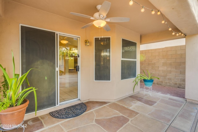 property entrance featuring ceiling fan and a patio area