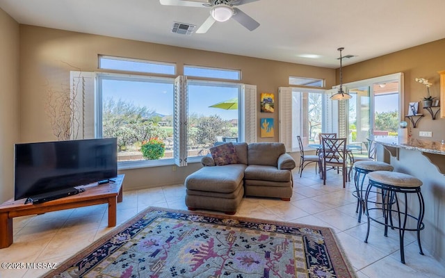 living room featuring ceiling fan and light tile patterned flooring