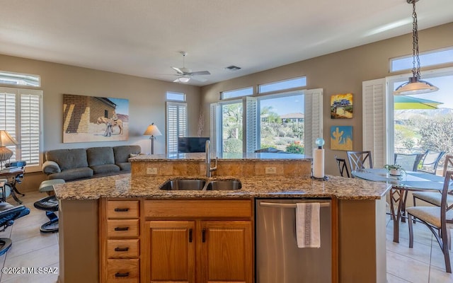 kitchen with dishwasher, sink, hanging light fixtures, ceiling fan, and light tile patterned flooring