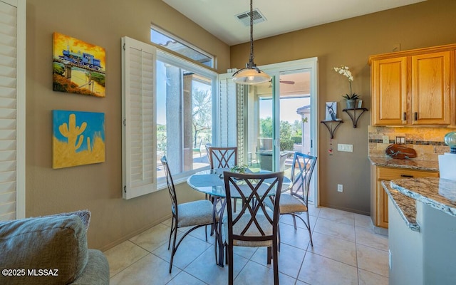 dining area with light tile patterned flooring