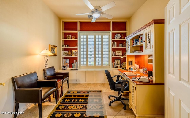 office featuring built in shelves, ceiling fan, and light tile patterned floors