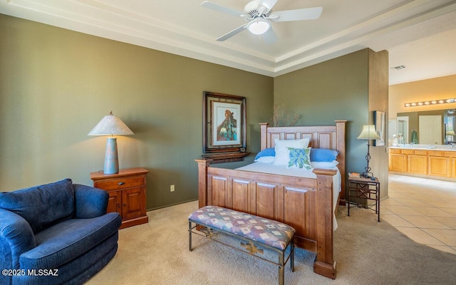 carpeted bedroom featuring ensuite bath and ceiling fan