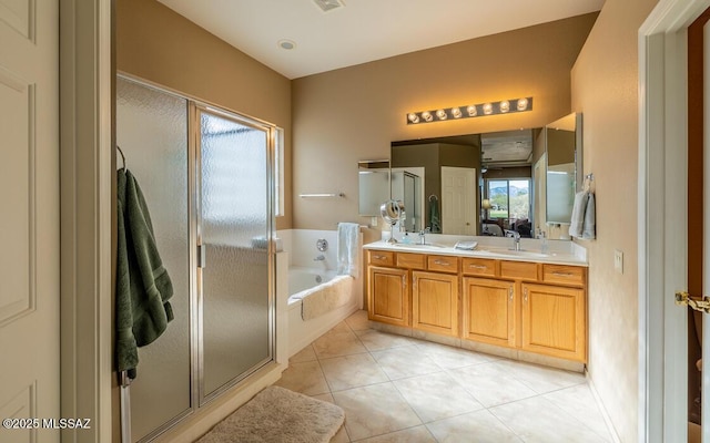 bathroom featuring tile patterned floors, vanity, and shower with separate bathtub