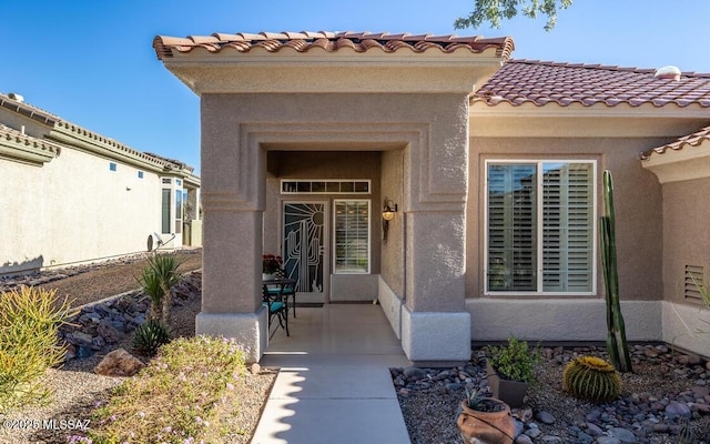 entrance to property with a patio