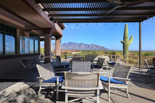 view of patio / terrace with a pergola and a mountain view