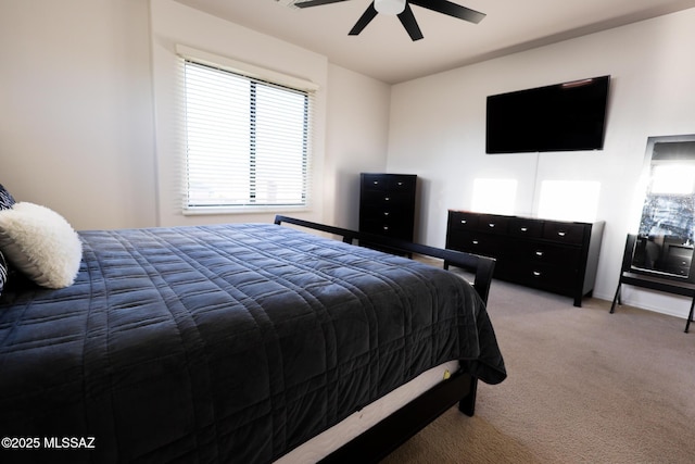 bedroom featuring light carpet and a ceiling fan