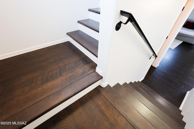 stairway with baseboards and wood finished floors