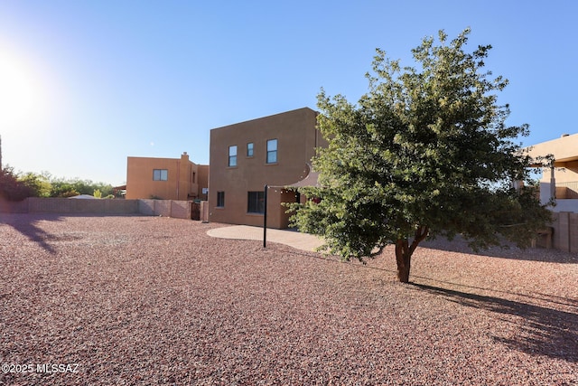 back of property with a patio, a fenced backyard, and stucco siding