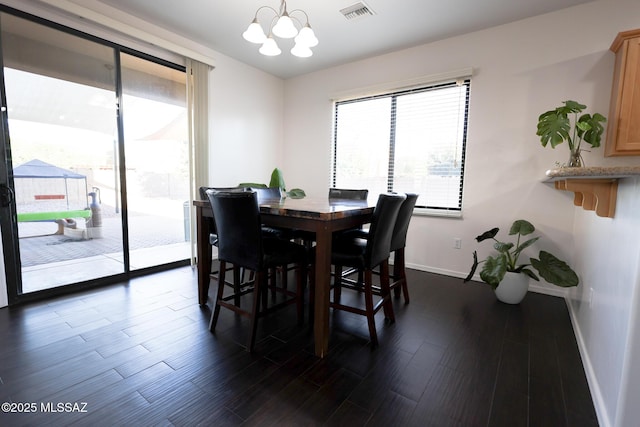 dining area with visible vents, plenty of natural light, a notable chandelier, and dark wood-style floors