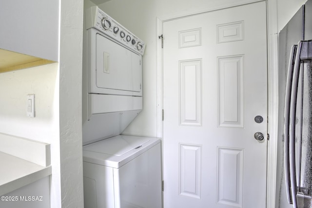 laundry room featuring stacked washer and dryer