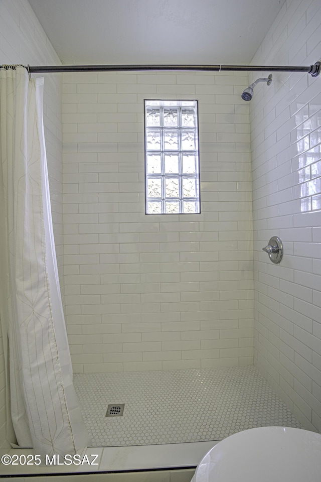 bathroom with a shower with curtain and toilet