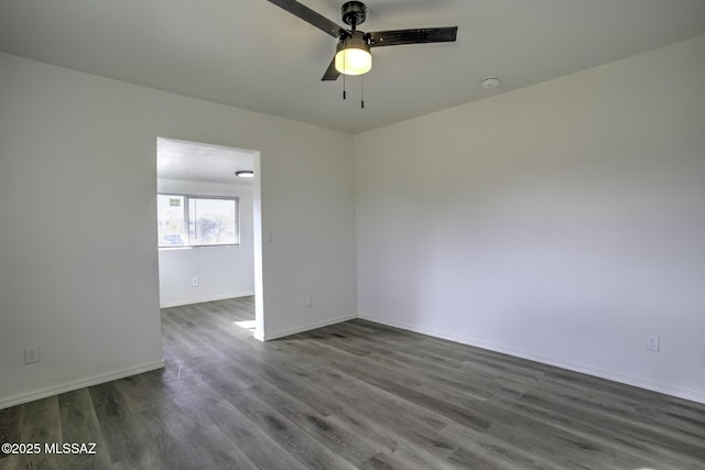 spare room featuring ceiling fan and dark hardwood / wood-style floors