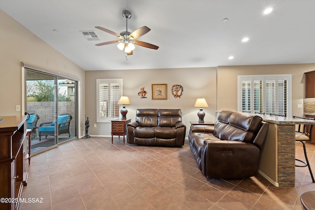 tiled living room featuring vaulted ceiling and ceiling fan