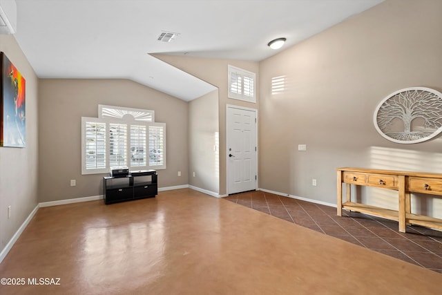 foyer featuring vaulted ceiling, dark tile patterned floors, and a wall mounted air conditioner