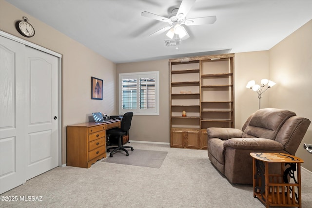 carpeted office with ceiling fan