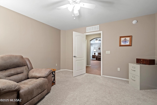 living area featuring ceiling fan and light carpet