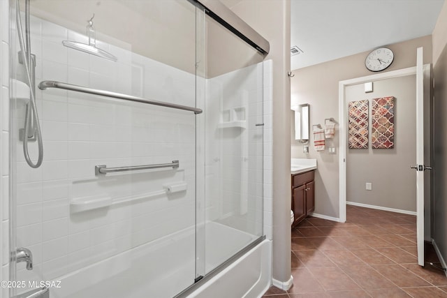 bathroom featuring tile patterned floors, vanity, and combined bath / shower with glass door