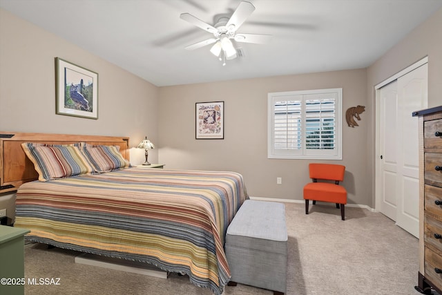 carpeted bedroom with a closet and ceiling fan