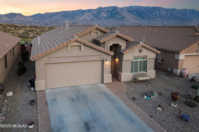 single story home featuring a mountain view and a garage