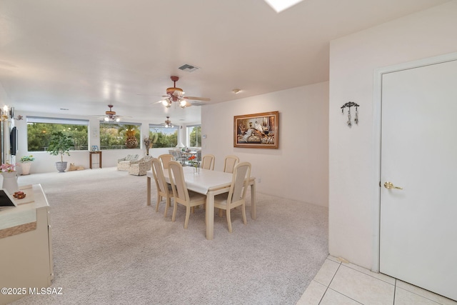 carpeted dining space featuring ceiling fan