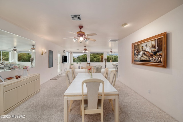 dining room with light colored carpet