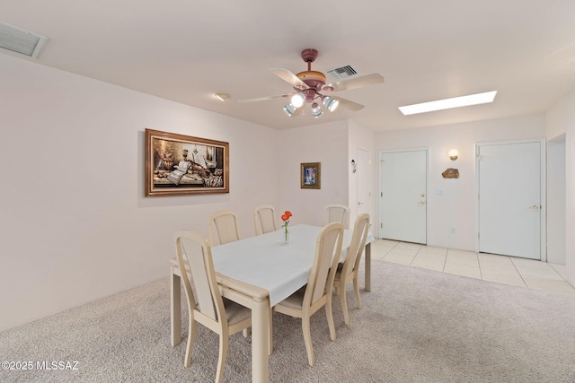 dining area featuring ceiling fan and light tile patterned floors