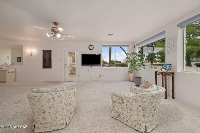 carpeted living room featuring ceiling fan