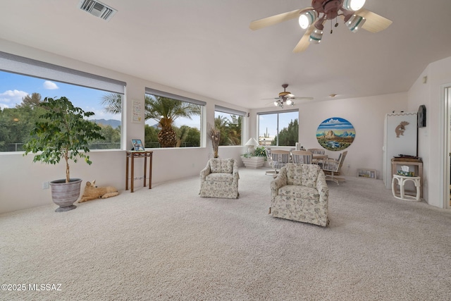 living room with ceiling fan and carpet