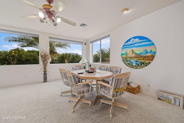 dining area featuring carpet and ceiling fan