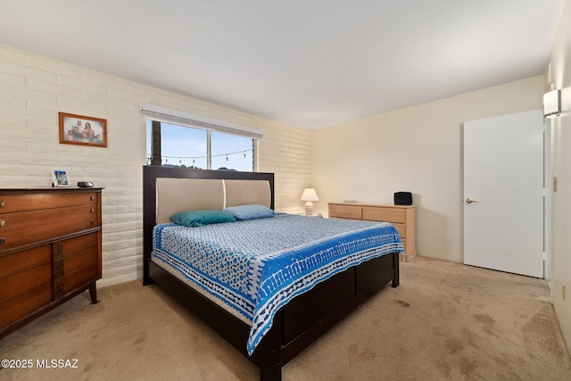 carpeted bedroom featuring brick wall