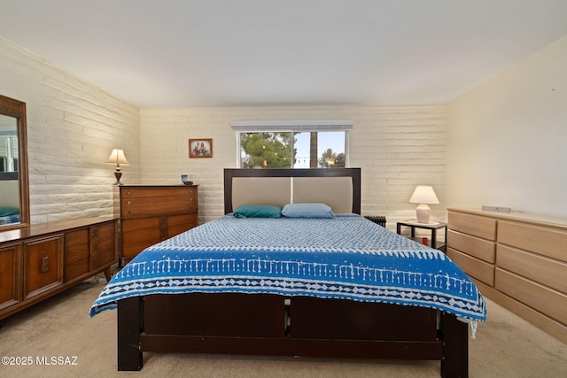 carpeted bedroom with brick wall