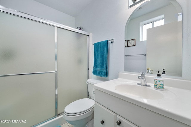 bathroom featuring vanity, toilet, and an enclosed shower