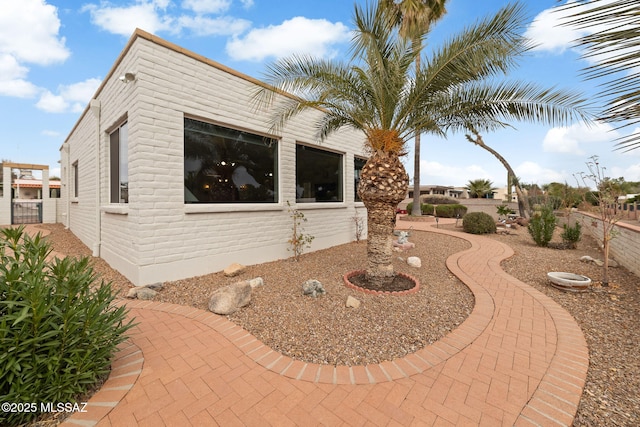 view of side of home with a patio area