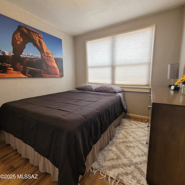 bedroom featuring hardwood / wood-style floors and multiple windows