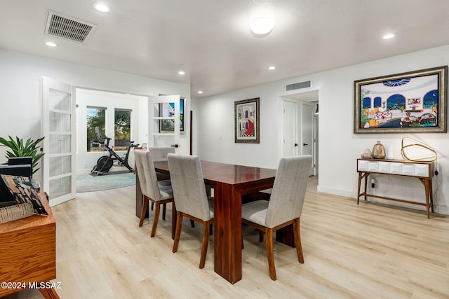 dining space featuring light hardwood / wood-style floors and french doors