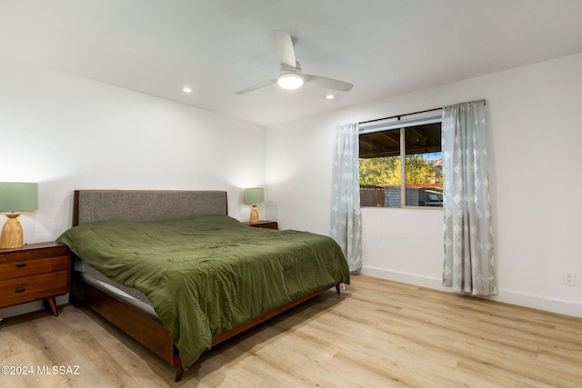 bedroom with light hardwood / wood-style flooring and ceiling fan