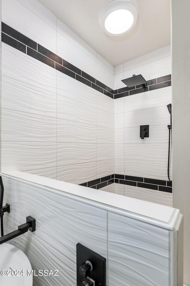 bathroom with a tile shower