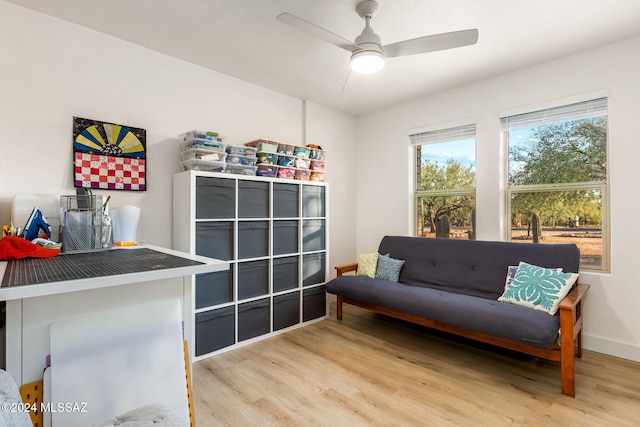 sitting room with ceiling fan and light hardwood / wood-style flooring